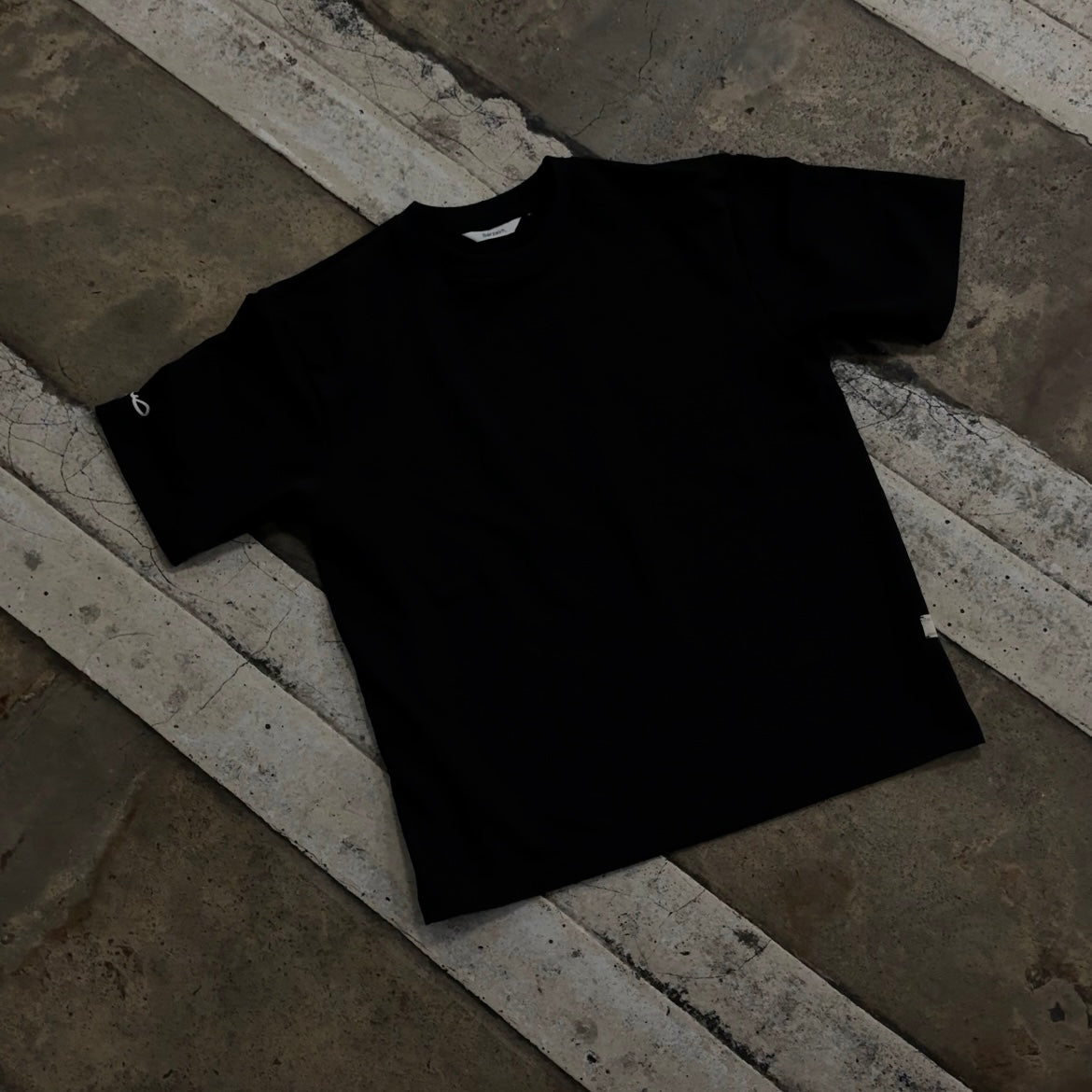 Black t-shirt on a stone surface